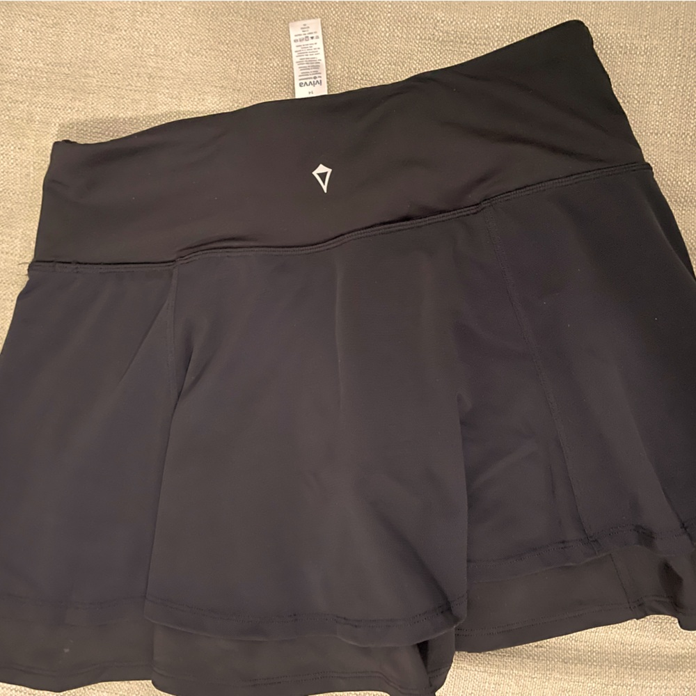 NWOT Ivivva black tennis skirt. Fits like a lululemon 2/4